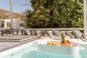 a pool with a table with a bowl of fruit on it at Ow Andros Suite 2,Private Whirlpool in Andros