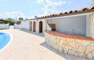 a patio with a swimming pool and a house at Villa Parisi con piscina in Syracuse