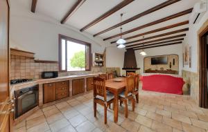 a kitchen with a wooden table and a red couch at Villa Parisi con piscina in Syracuse
