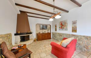 a living room with a red couch and a fireplace at Villa Parisi con piscina in Syracuse