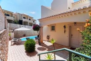 a villa with a pool and a house at Sunset Villa in Ferragudo