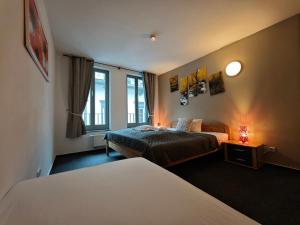 a hotel room with two beds and a window at Bacchus Holiday Homes in Bacharach