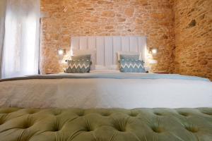 a bedroom with a large bed with two pillows at Casa Rural Berrenda in Tiscamanita +26 photos