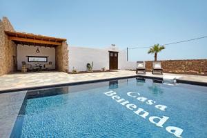 a swimming pool in front of a house at Casa Rural Berrenda in Tiscamanita