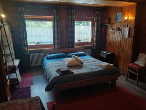 a bedroom with a bed with two pillows on it at Maison Olga - La Roisette in Valtournenche