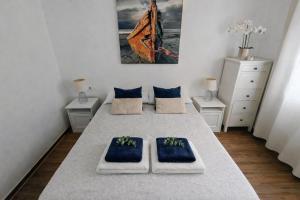 a room with a bed with two blue pillows on it at Binimar - Cala en Porter in Cala en Porter