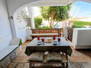 a table and chairs on a balcony with a table at Binimar - Cala en Porter in Cala en Porter