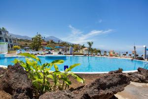 a large swimming pool with rocks in front of a resort at Casa Ana in Santa Úrsula