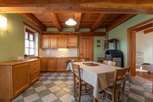 a kitchen with a table and chairs in a room at Civico 11 in Marmora