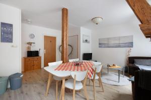 a kitchen and living room with a table and chairs at Felsenburg in Ahrenviölfeld