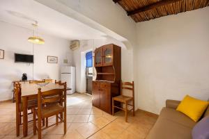 a kitchen and living room with a table and a couch at Quinta da Amendoeira in Foz