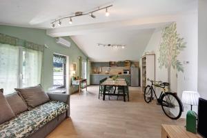 a living room with a couch and a table at Mansarda Albero Verde con Piscina in Casanova Lerrore
