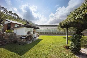 a gazebo in a yard with a bridge in the background at Mansarda Albero Verde con Piscina in Casanova Lerrore