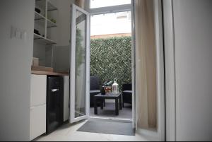a door leading into a room with a table at Eralight21 Apartments in Bari