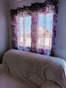 a bedroom with a bed and a window at Valley T2 duplex in Vila Nova de Foz Coa