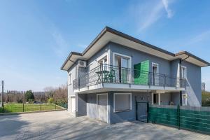 a large house with a balcony on a street at Sweet Home Apartments Bambù in Arona