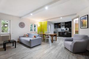 a living room with two couches and a table at Sweet Home Apartments Bambù in Arona