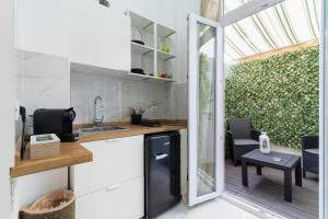 a small kitchen with a sink and a table at Eralight21 Apartments in Bari