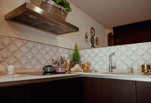 a kitchen with a sink and a counter top at Fonte do Pinheiro Boutique in Ponte de Lima +31 photos