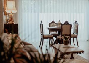 a living room with a couch and a table and chairs at Fonte do Pinheiro Boutique in Ponte de Lima