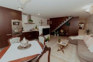 a living room with a couch and a table and a kitchen at Fonte do Pinheiro Boutique in Ponte de Lima