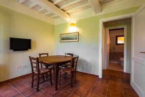 a dining room with a table and chairs at Rosaspina - Appartamento 2 in Capalbio