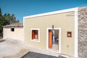a building with an orange door on the side at Rodies House in Rhodes Town