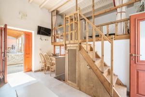 a loft conversion with a wooden staircase in a room at Rodies House in Rhodes Town