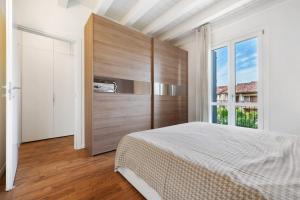 a bedroom with a bed and a large window at Appartamento Castello a Raffa in Puegnago +17 photos