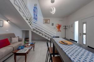 a living room with a table and a staircase at Meravigliosalento in Squinzano