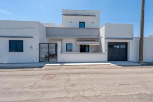 a white house with a driveway in front of it at Meravigliosalento in Squinzano