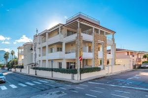 a white building on the side of a street at Cormorani - Appartamento 8 in Golfo Aranci
