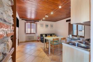 a kitchen with a sink and a table in a room at Il Vicolino in Pettenasco