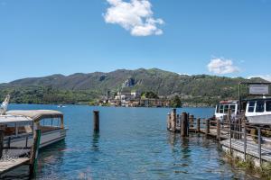 two boats are docked at a dock on a lake at Il Vicolino in Pettenasco