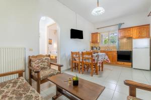 a living room with a kitchen and a dining room at Olivea Apt 1 in Acharavi