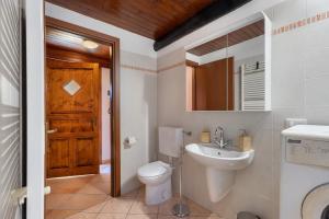 a bathroom with a toilet and a sink at Il Vicolino in Pettenasco +19 photos