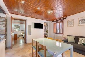a living room with a table and a couch at Il Vicolino in Pettenasco