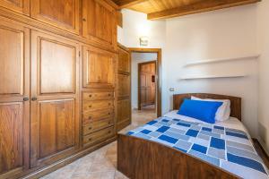 a bedroom with a bed and wooden cabinets at Girasole in Pula