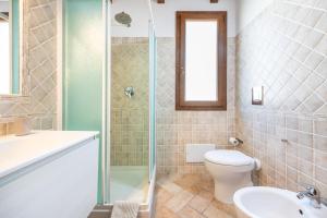 a bathroom with a toilet and a sink and a shower at Girasole in Pula +24 photos