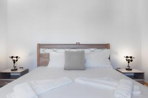 a bedroom with a white bed with white sheets and pillows at Nicolas House 1 in Rakhídhion