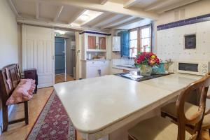 a kitchen with a large white island in a room at Casa La Calleja in Arzúa