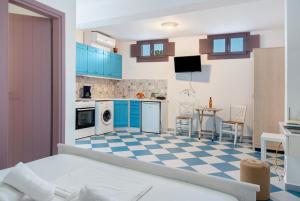 a kitchen with blue cabinets and a checkered floor at Nicolas House 3 in Rakhídhion