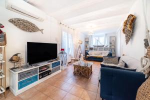 a living room with a flat screen tv at Maison type Canetoise prox plage in Canet-en-Roussillon