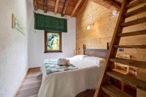 a bedroom with a bed in a wooden house at Le Fratte in Pertica Alta