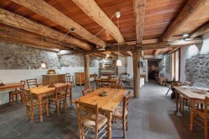 a dining room with wooden tables and chairs at Le Fratte in Pertica Alta