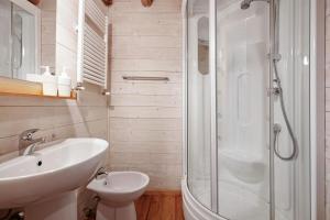 a white bathroom with a sink and a shower at Le Fratte in Pertica Alta