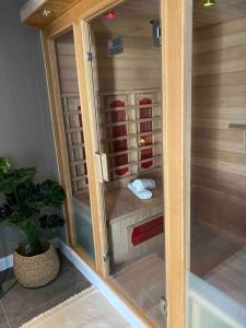 a shower with a glass door in a bathroom at Le Wellness des alpagas in Huy +39 photos