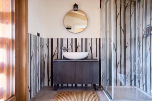 a bathroom with a sink and a mirror at Bellagio - Baita treeb Tramontana in Bellagio +37 photos