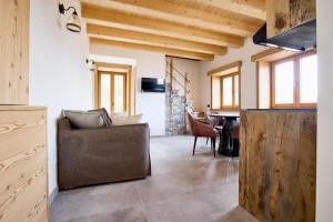 a living room with a couch and a table at Bellagio - Baita treeb Tramontana in Bellagio