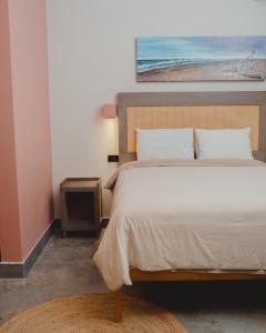 a bedroom with a bed and a painting on the wall at Hotel Calma Celesti in Perihuete +15 photos